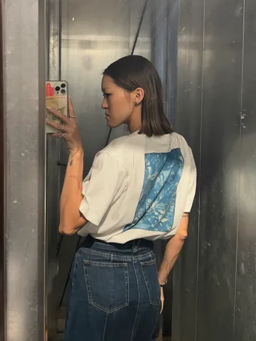 Woman in a white T-shirt with a cyanotype print on the back
