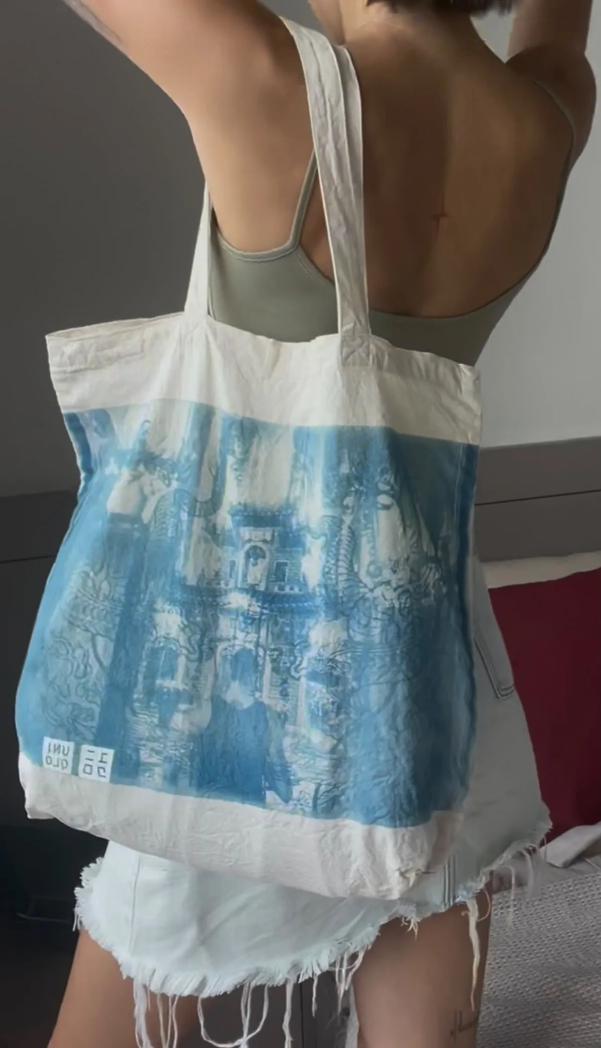 Cotton tote bag with a cyanotype print, worn on the shoulder